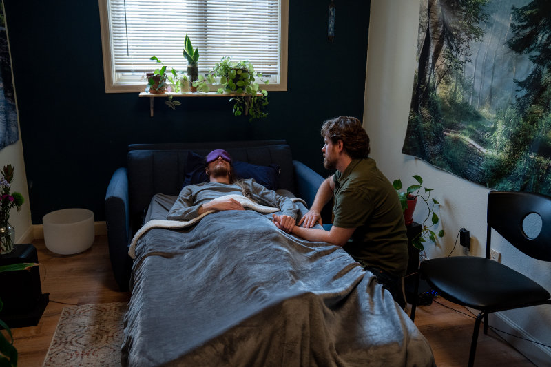 Psychedelic guide providing support to a client undergoing legal psychedelic therapy